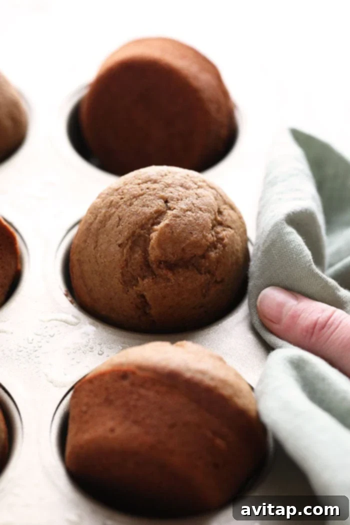 A close-up shot of perfectly baked healthy banana bread muffins, golden brown and inviting.