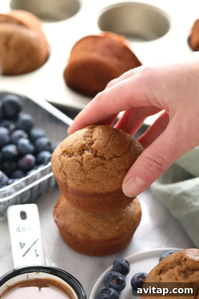 A pair of beautifully baked banana bread muffins, soft and golden brown, ready to be eaten.