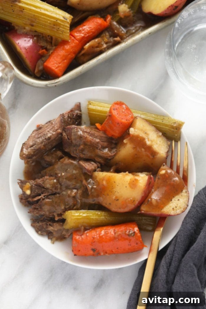 Delicious Instant Pot pot roast served on a plate with tender vegetables and gravy