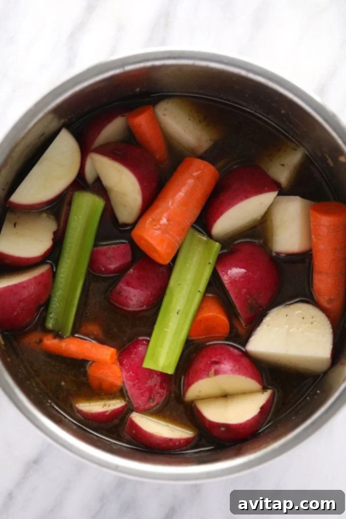 pot roast veggies in the instant pot ready to be pressure cooked