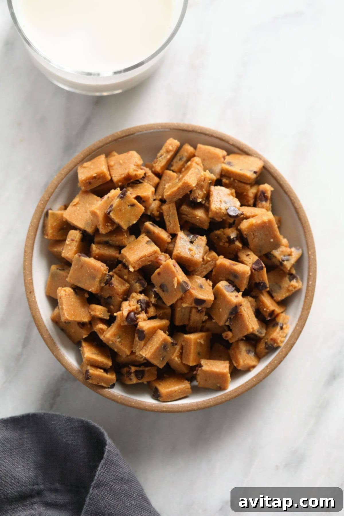 Edible Vegan Cookie Dough Delights 2 Delicious vegan cookie dough bites piled high in a rustic bowl, ready for snacking.