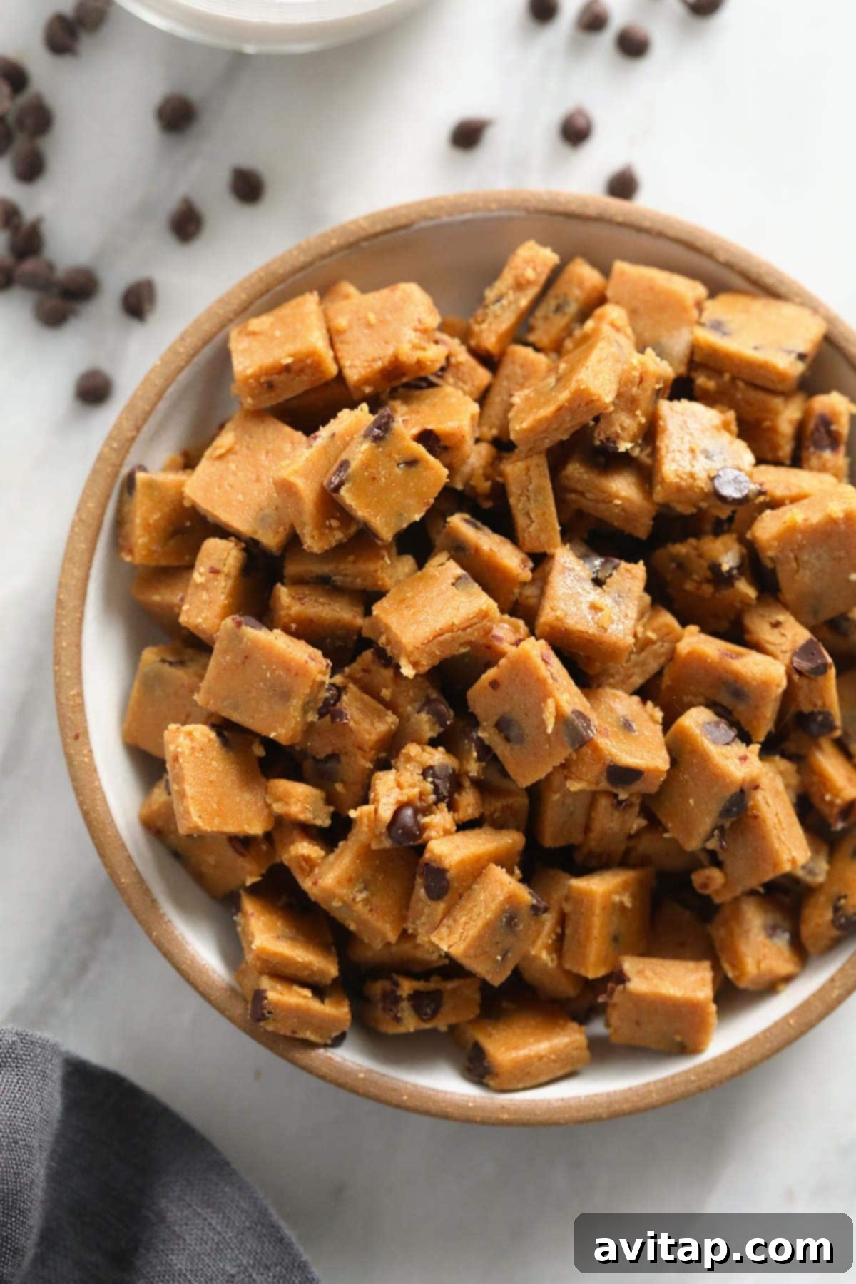Edible Vegan Cookie Dough Delights 6 Close-up of a bowl filled with perfectly cut vegan cookie dough bites, showcasing their tempting texture.