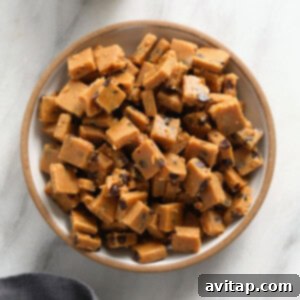 Edible Vegan Cookie Dough Delights 5 A bowl of delicious vegan cookie dough bites topped with a spoonful of peanut butter fudge.