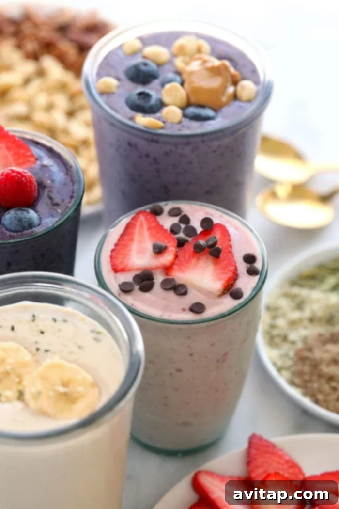 Four vibrant protein shakes in various glasses, showcasing different flavors and textures, ready to be enjoyed.