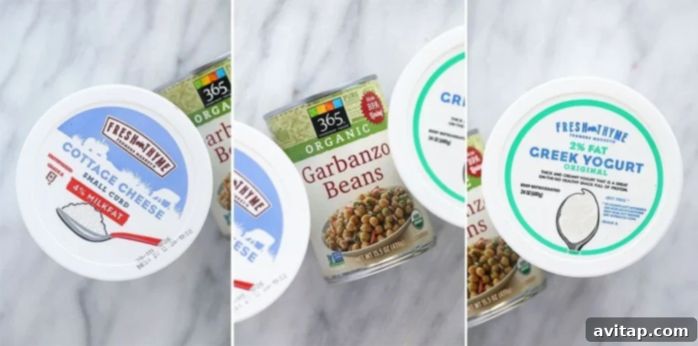 A diverse selection of protein-rich foods, including nuts, seeds, and yogurt, on a counter.
