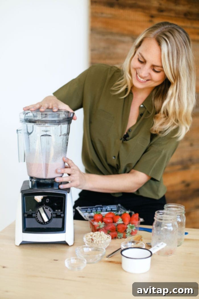 A person confidently operating a high-speed blender, preparing a healthy protein shake, emphasizing ease of use.