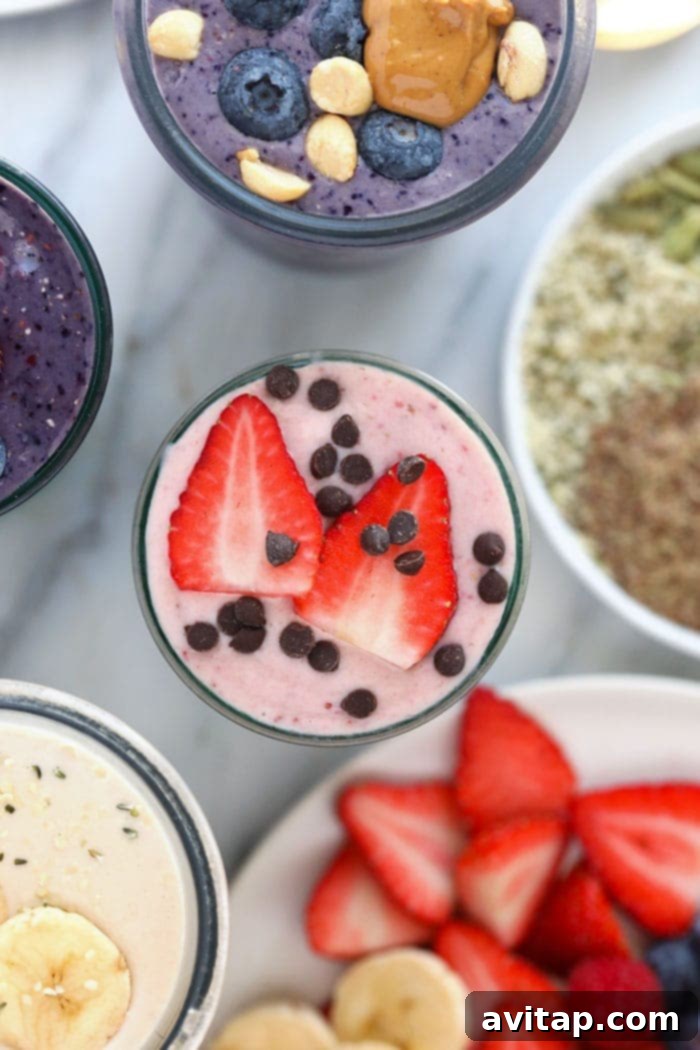 A vibrant strawberry protein shake in a tall glass, garnished with fresh berries and a hint of cream, resembling a cheesecake dessert.