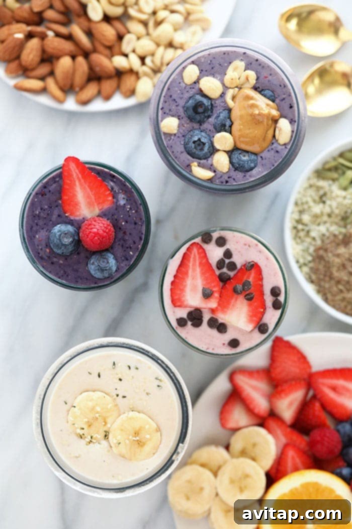 A selection of colorful homemade protein shakes arranged on a clean kitchen counter, highlighting variety.