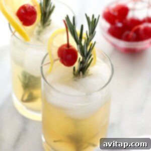 Rosemary Collins cocktail in a small glass, garnished with rosemary and lemon.