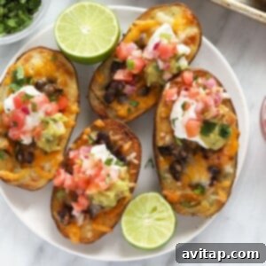 Close-up of a finished Mexican potato skin with guacamole and Greek yogurt on a plate.