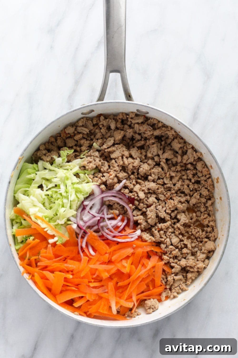 egg roll in a bowl recipe ingredients in a skillet ready to be sauteed