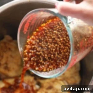 Pouring in honey garlic sauce over chicken.