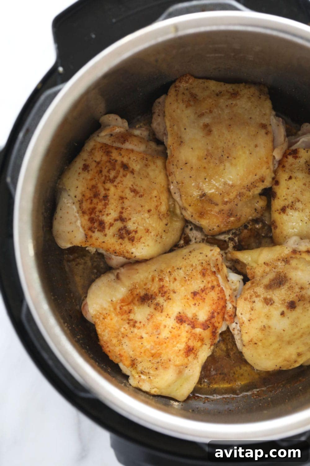 Chicken thighs being seared in the Instant Pot