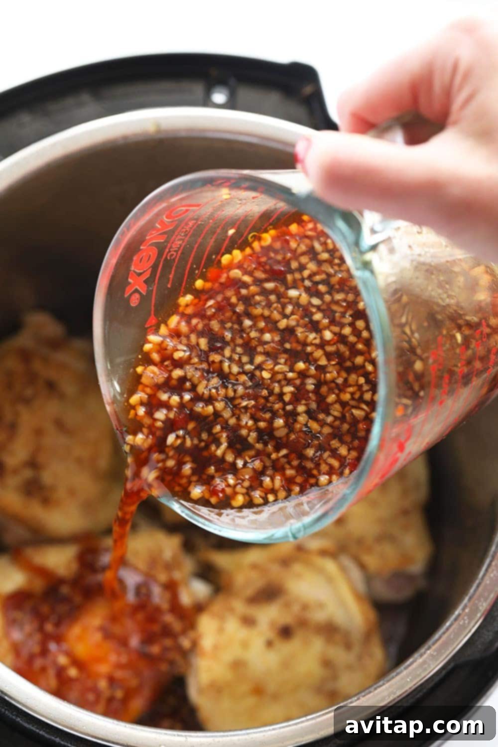 Honey garlic sauce in a glass jar, ready for use.
