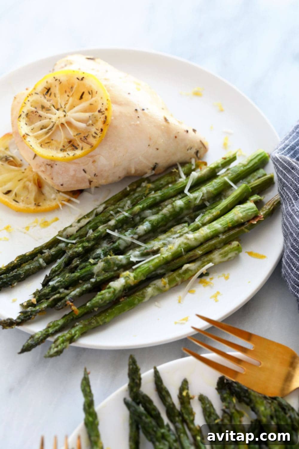 Roasted asparagus served alongside a perfectly cooked chicken breast.