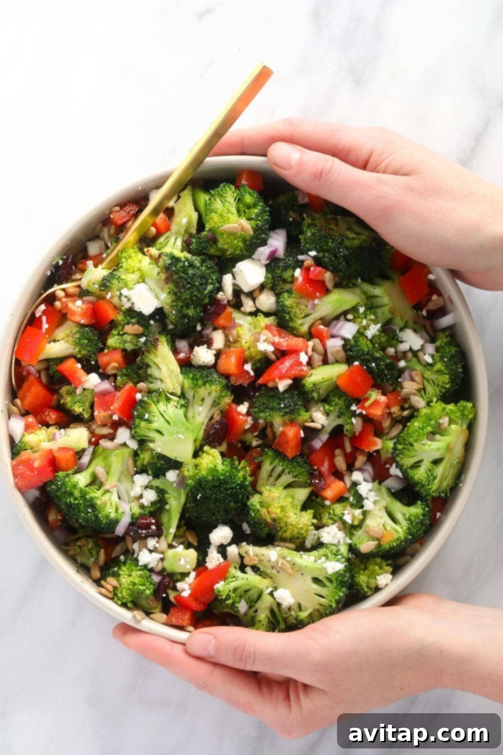 Freshly prepared broccoli salad in a elegant white bowl, garnished and ready to be served