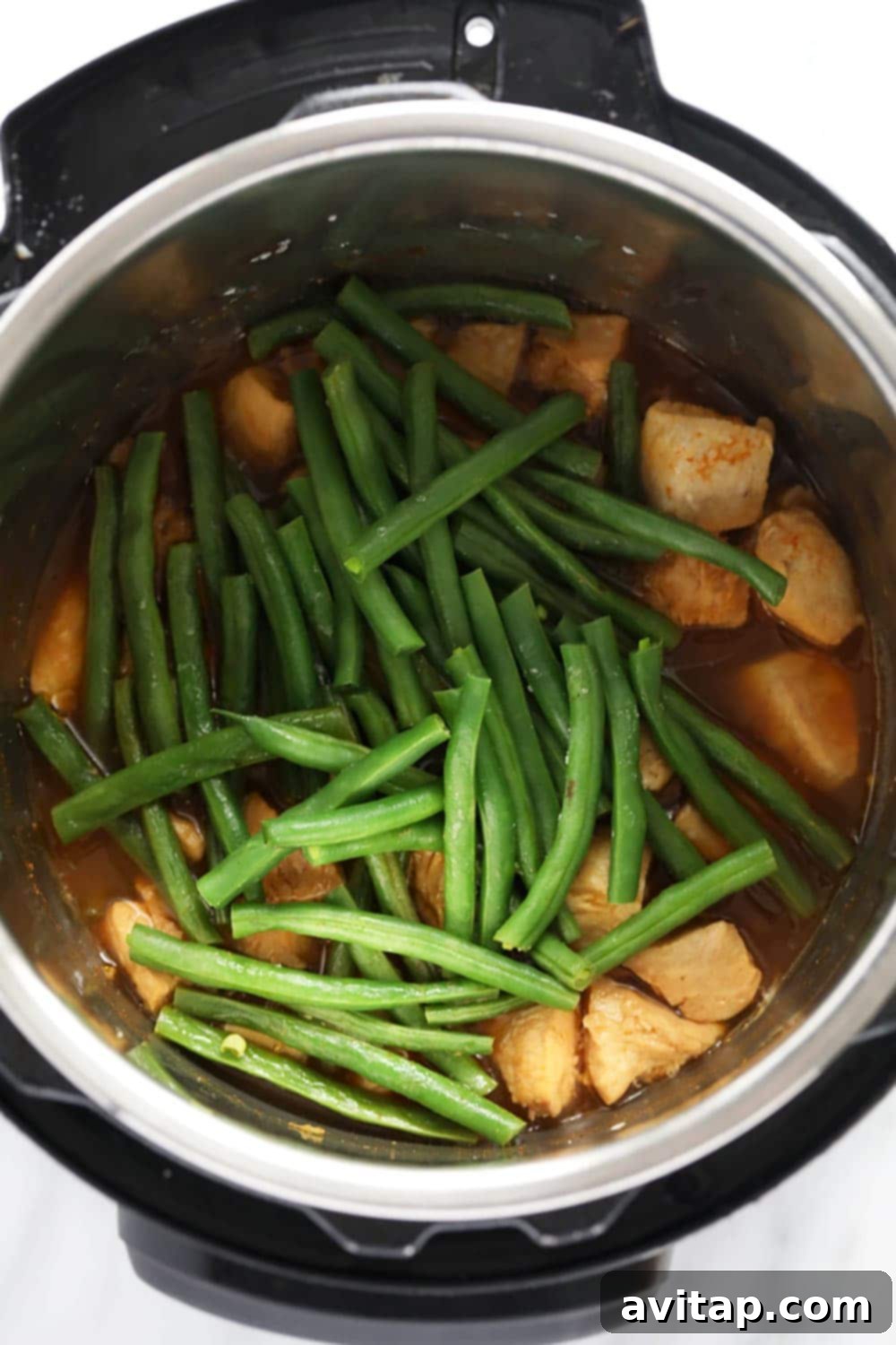 This Instant Pot Orange Chicken is saucy, flavorful, and so easy to make! All you need is your Instant Pot and the ingredients and you will have delicious take-out-tasting orange chicken in less than 30 minutes! Chicken and green beans in the Instant Pot
