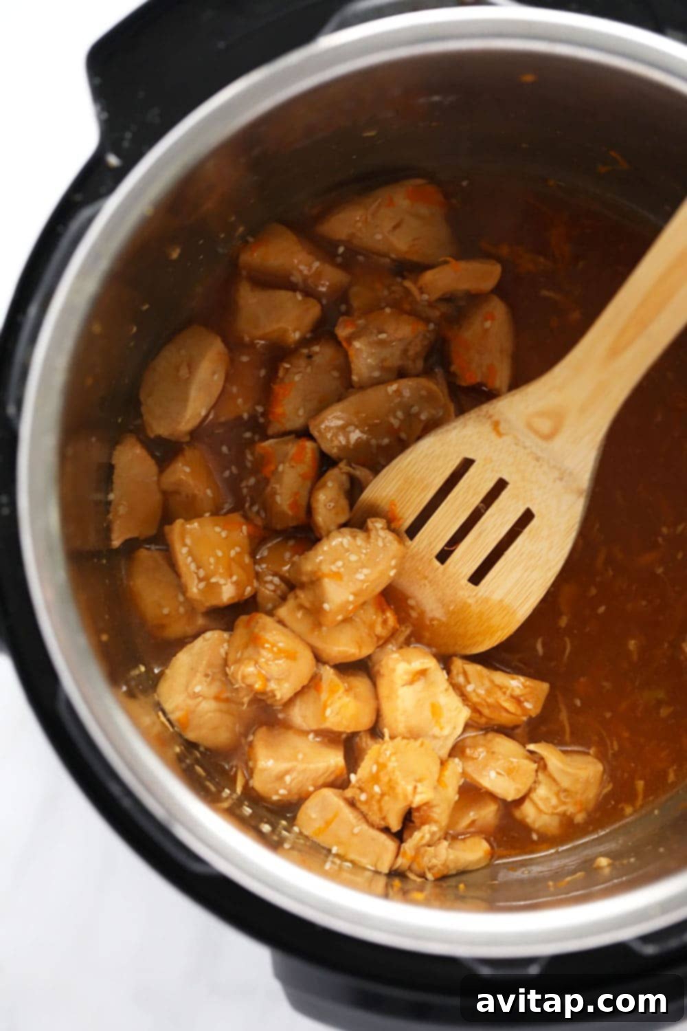This Instant Pot Orange Chicken is saucy, flavorful, and so easy to make! All you need is your Instant Pot and the ingredients and you will have delicious take-out-tasting orange chicken in less than 30 minutes! Orange Chicken in sauce in the Instant Pot