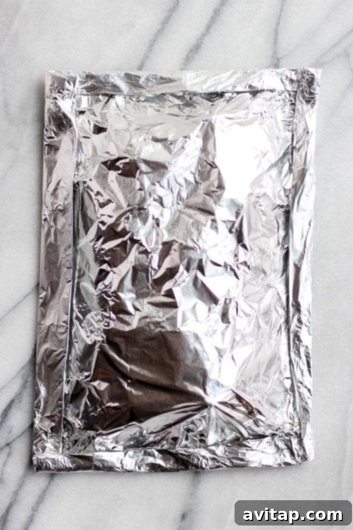 Assembled foil pack of seasoned potatoes ready for the grill