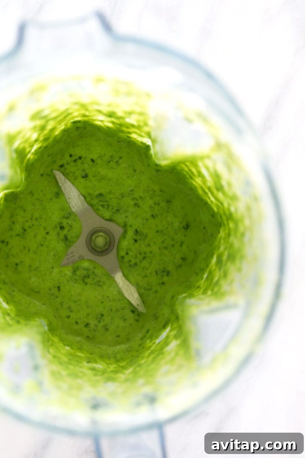 Smoothly blended spinach base for healthy muffins Blended spinach, banana, and Greek yogurt mixture in a blender, ready for other ingredients.