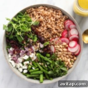 Farro salad in a bowl, ready to be served, with fresh ingredients clearly visible.