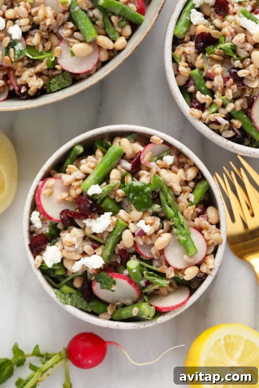 A close-up of the finished farro salad in a bowl, showing texture and fresh ingredients.