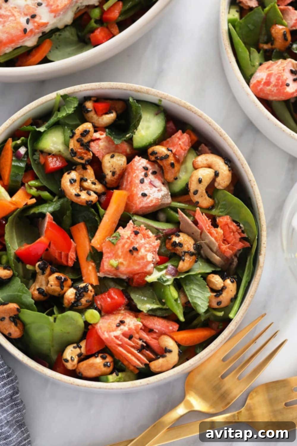 Close-up of a single serving of the finished Thai Salmon Salad in a modern, stylish bowl, highlighting the textures, vibrant colors, and inviting presentation.