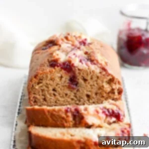 A whole lemon bread loaf with visible swirl and lemon zest.