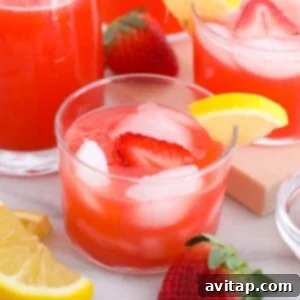 Strawberry vodka lemonade in a glass with garnishes
