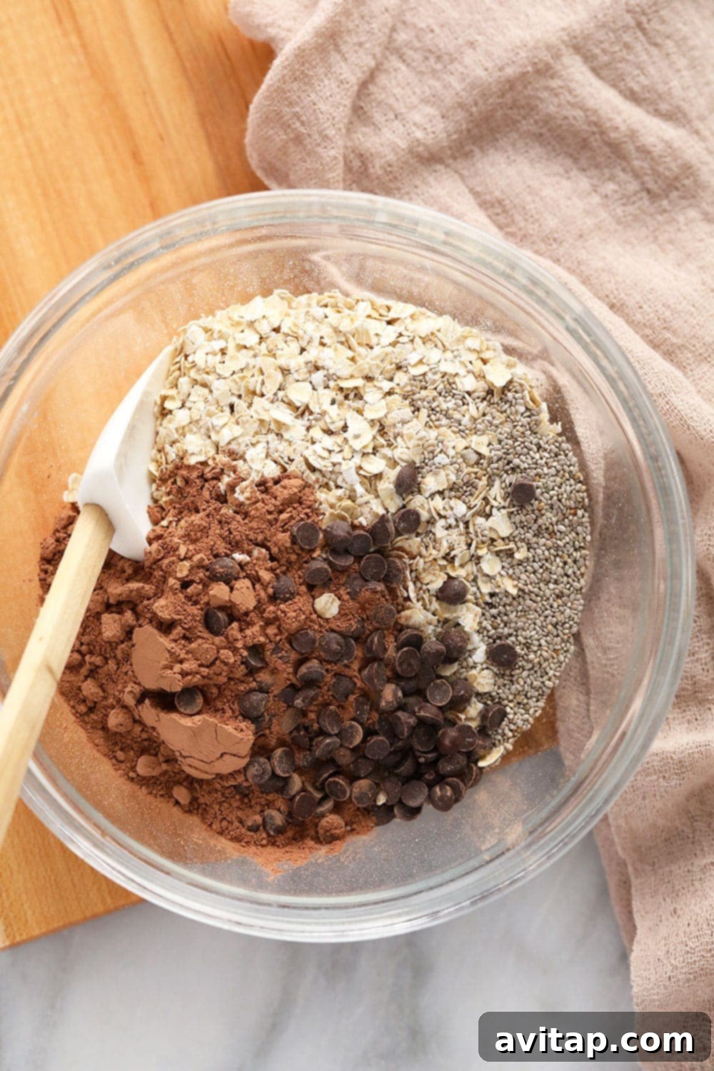 Simple Dry Ingredients for Your Speediest Mocha Oats A bowl containing only the dry ingredients for Quick Mocha Overnight Oats, including quick oats, cocoa powder, and chia seeds, poised for the addition of liquids and mixing.