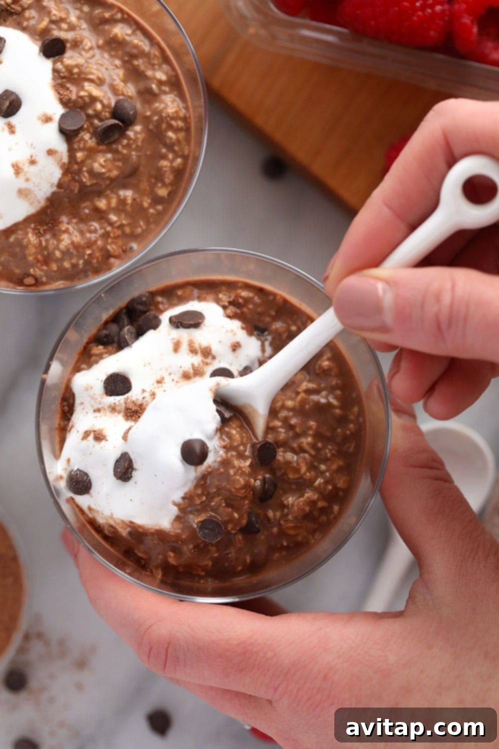 Your Perfect Bowl of Ready-to-Eat Mocha Overnight Oats A beautifully presented bowl of Quick Mocha Overnight Oats, generously topped with mini chocolate chips, with a spoon resting in it, signifying it's ready to be enjoyed.