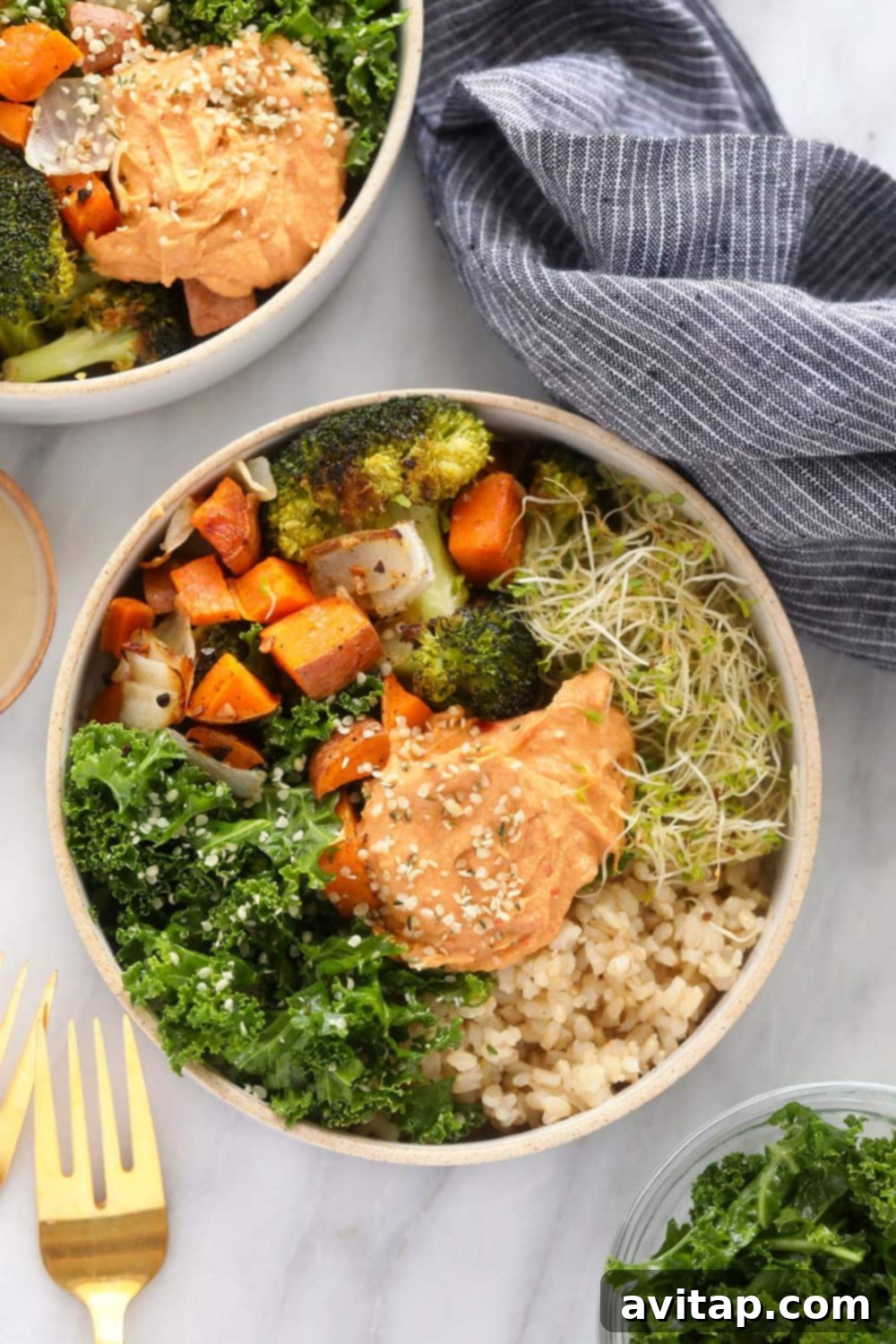 Vibrant vegetarian brown rice bowl topped with creamy hummus and fresh greens, ready to be served