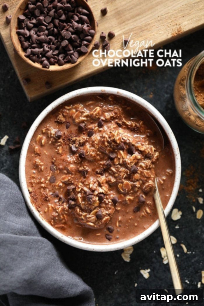 Close-up of a bowl of chocolate chai vegan overnight oats, garnished with spices and cocoa powder