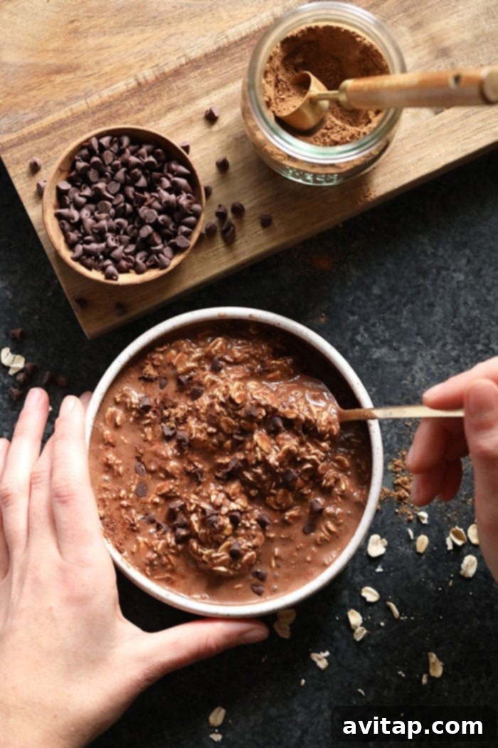 Close-up of a spoonful of chocolate chai vegan overnight oats, highlighting the creamy texture and spice specks