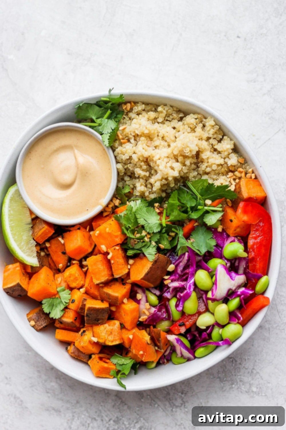 The Secret to Fluffy Quinoa 4 A vibrant Thai Coconut Quinoa Bowl, packed with colorful vegetables and creamy peanut sauce.