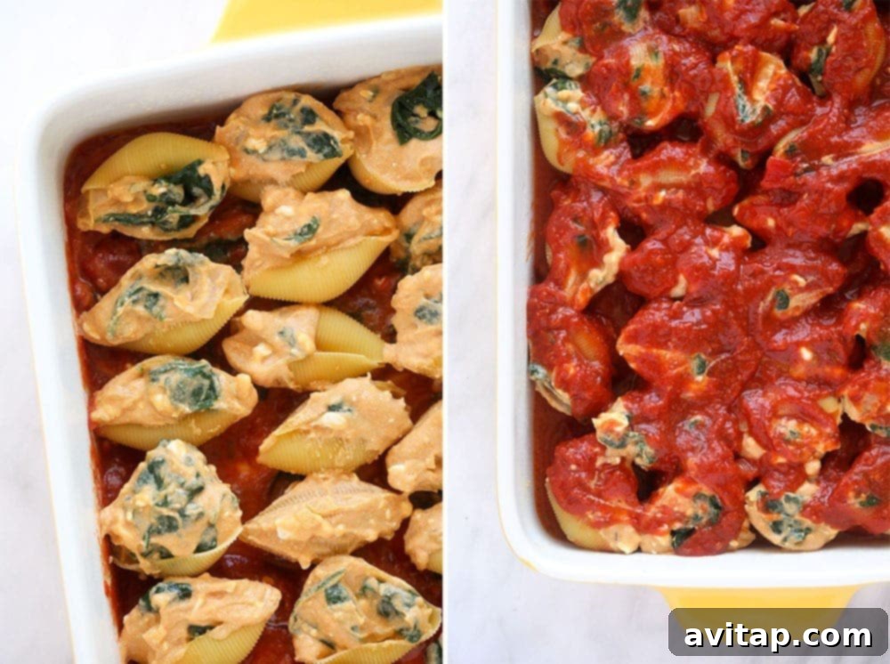 Uncooked jumbo pasta shells, generously stuffed with vegetarian filling and nestled in marinara sauce in a casserole dish, ready for baking.