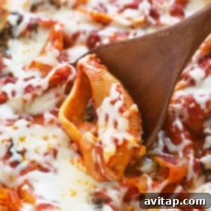 A wooden spoon is being used to scoop up a stuffed pizza.