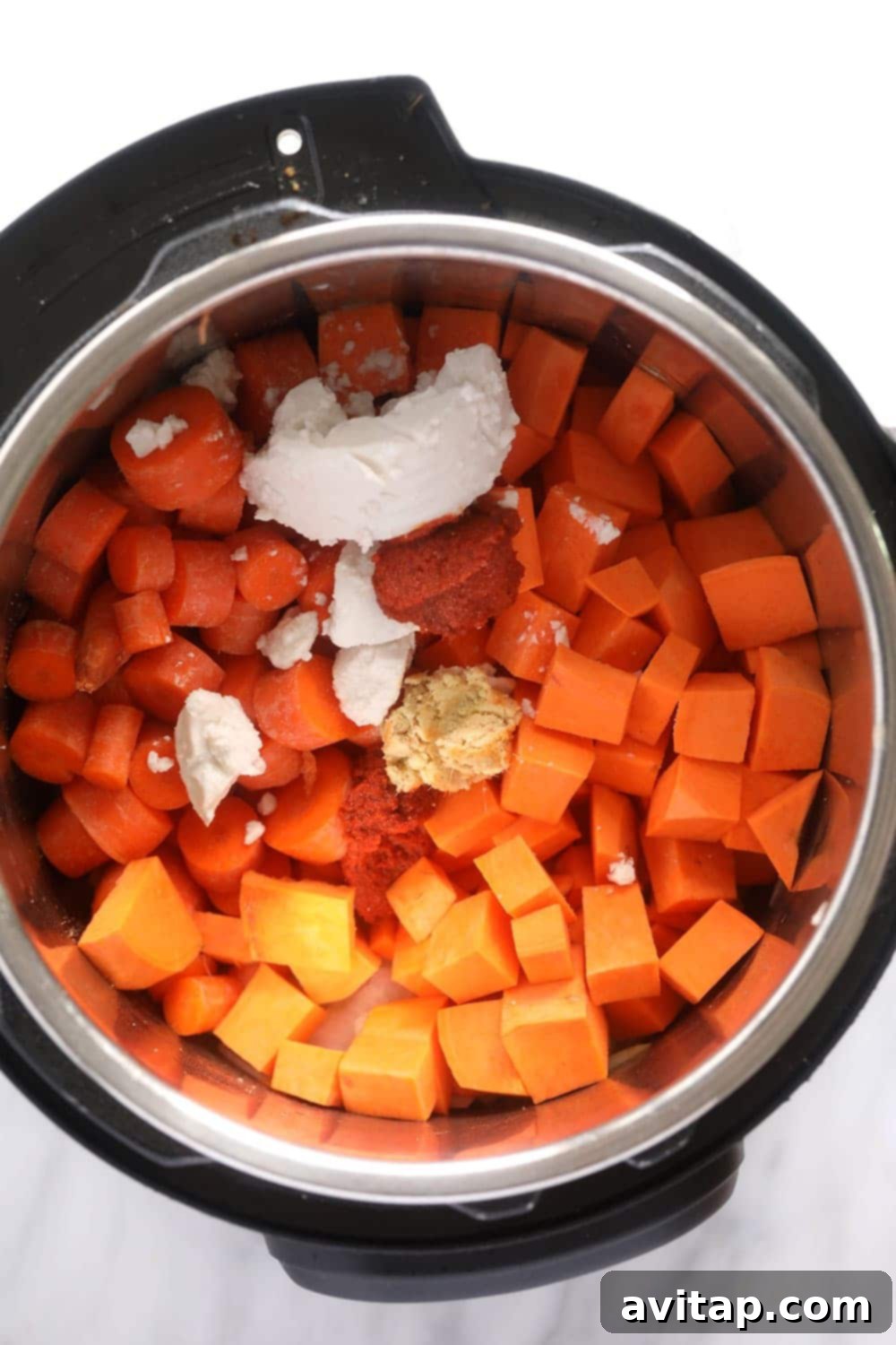 Raw ingredients for Instant Pot sweet potato carrot ginger soup inside the Instant Pot before cooking.