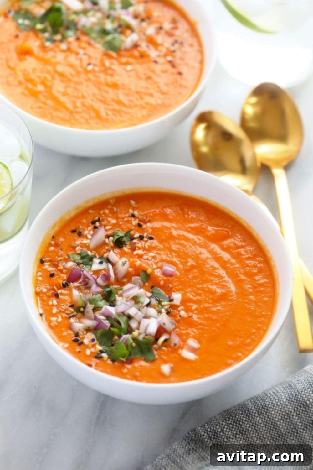 A bowl of creamy Instant Pot sweet potato carrot ginger soup, garnished and ready to be enjoyed.