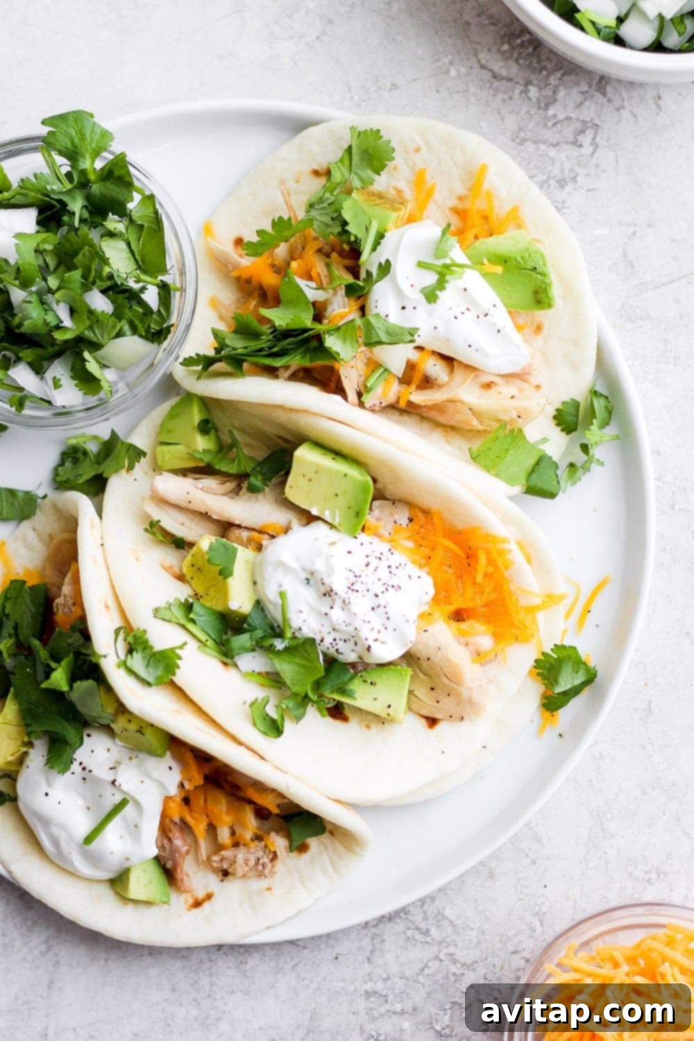 Delicious shredded chicken tacos ready to be served on a vibrant plate
