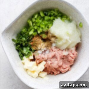 Ground turkey and spices mixed in a bowl, ready for patty formation.