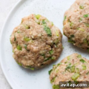 Formed raw turkey burger patties on a plate.