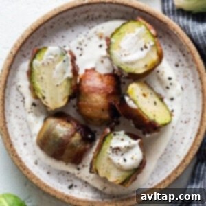 Plated bacon-wrapped Brussels sprouts with a side of aioli.