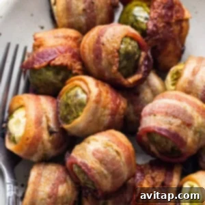 A dish of bacon wrapped brussels sprouts, ready to be served.