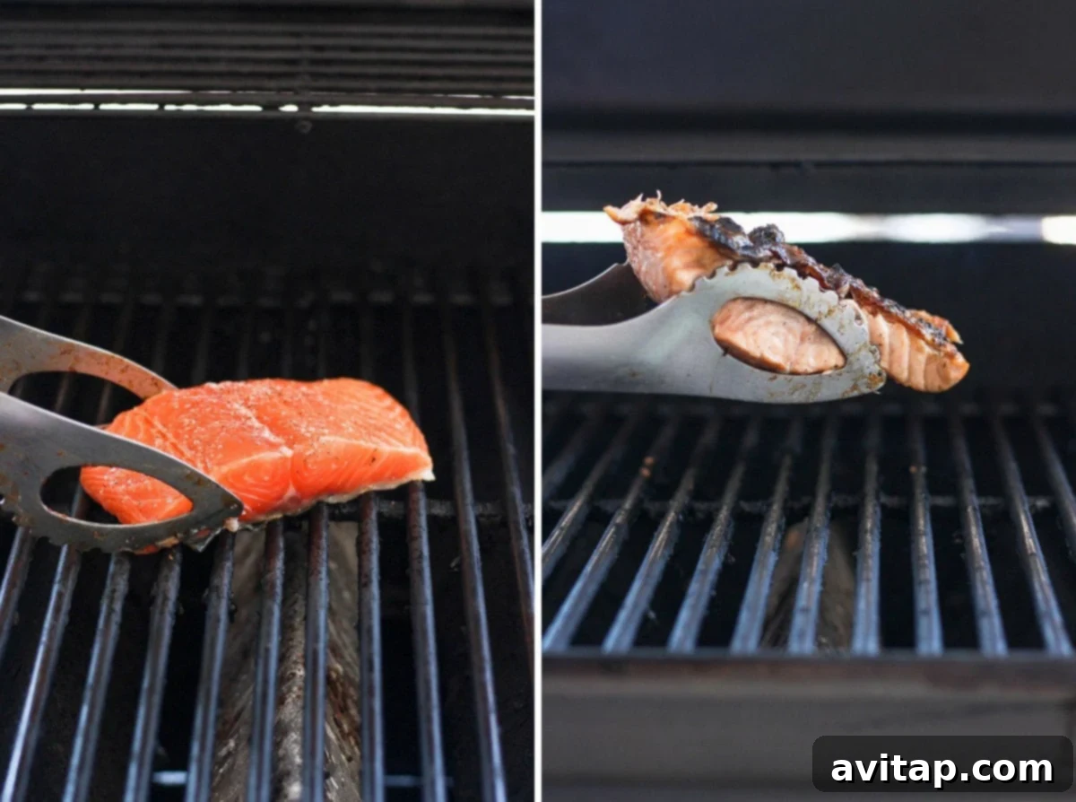 A glistening salmon fillet cooking on a gas grill, demonstrating the perfect skin-side-down technique.
