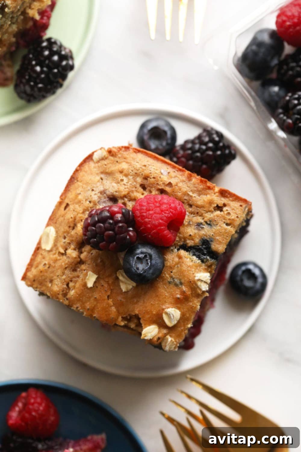 Moist and Delicious Triple Berry Breakfast Bread Close-up of a generous slice of Triple Berry Breakfast Bread, showing the moist crumb and visible berries.