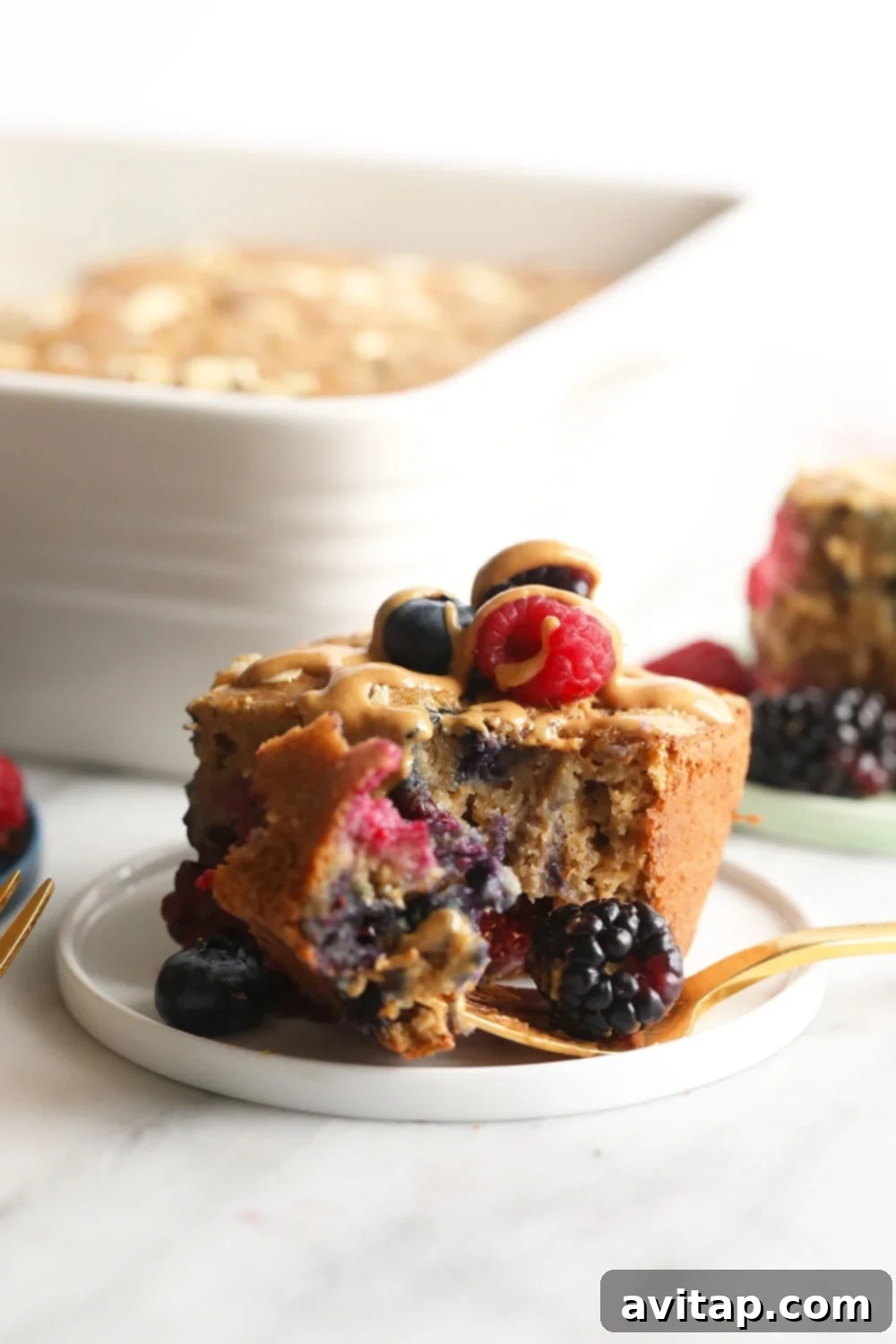 Delicious Triple Berry Breakfast Bread with Fresh Toppings A beautifully styled plate with a slice of Triple Berry Breakfast Bread, fresh berries, and a drizzle of syrup, ready to be enjoyed.