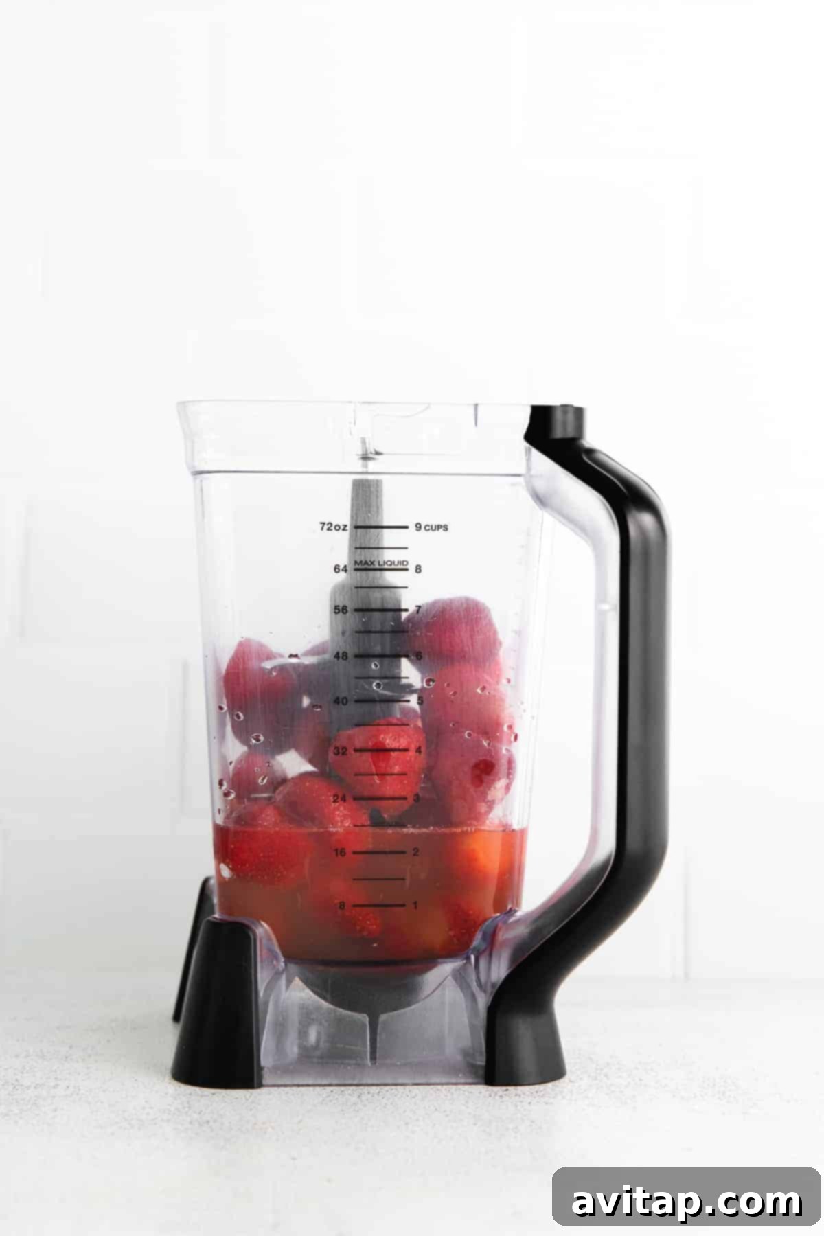 A seriously delicious frozen strawberry daiquiri made with just 4 ingredients - frozen strawberries, lime juice, simple syrup, and rum. strawberries and rum in blender