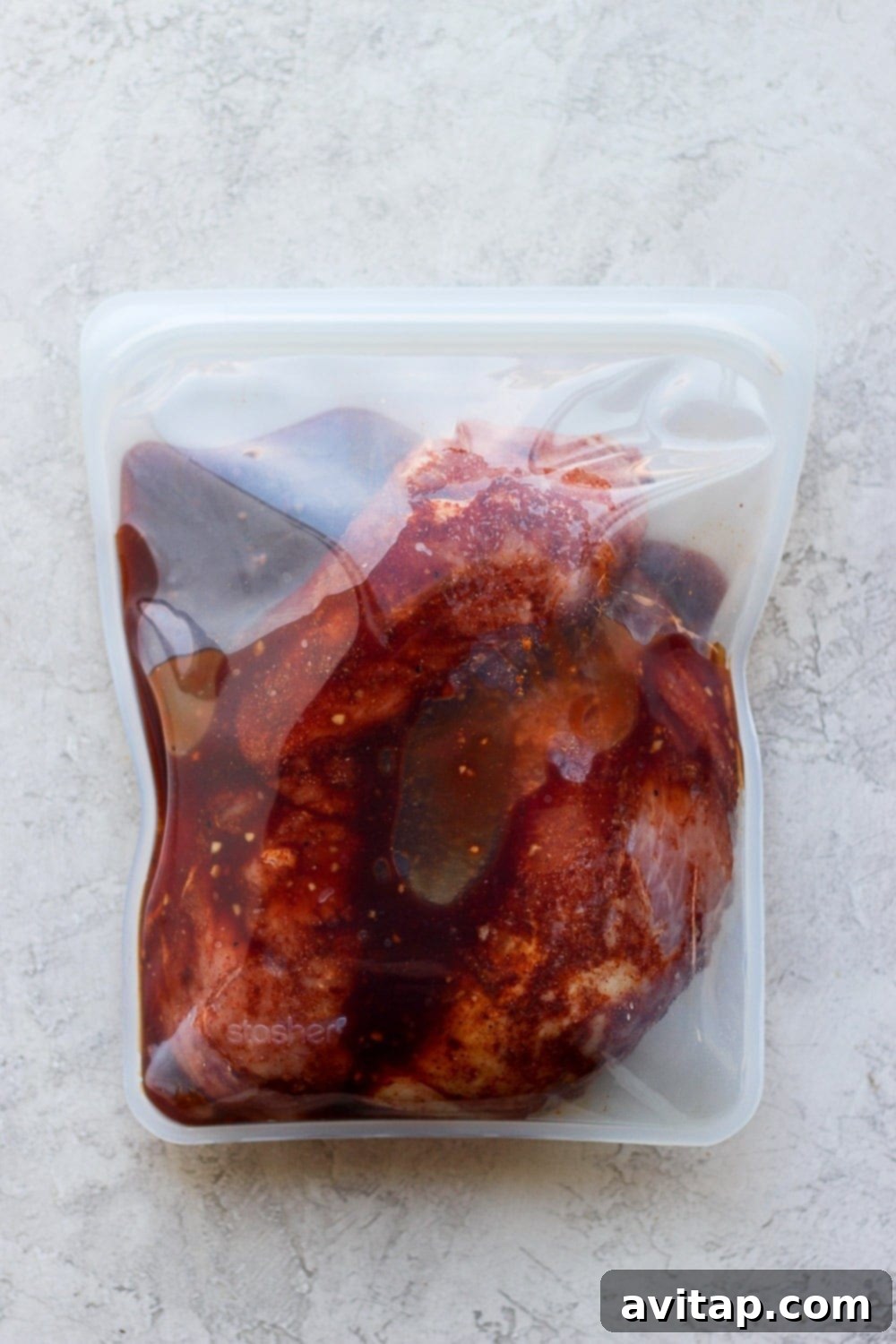 Pork tenderloins marinating in a Stasher bag with a rich, savory sauce.