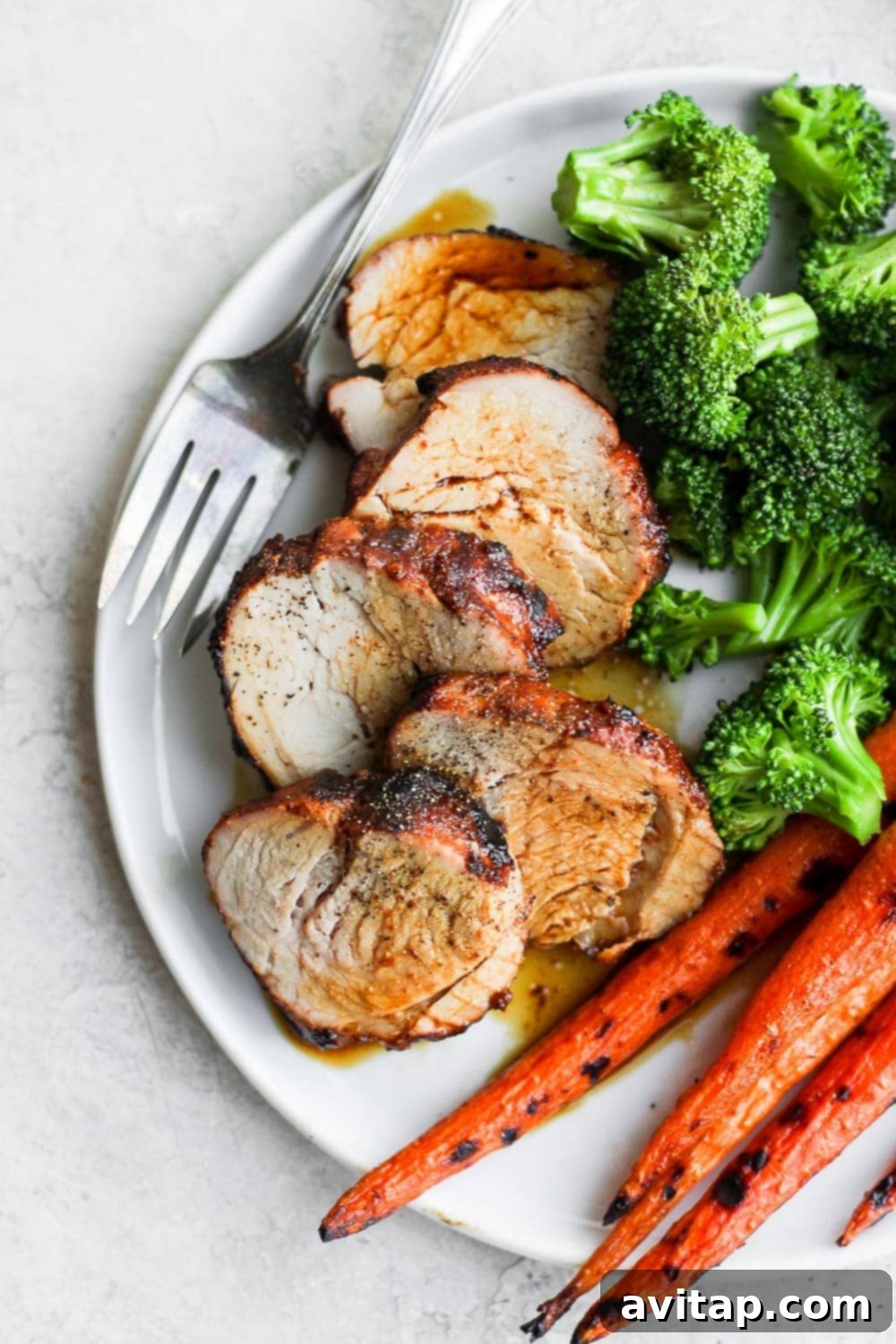 Close-up of perfectly sliced grilled pork tenderloin, showing its juicy and tender texture.